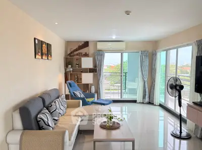 Spacious living room with modern decor and balcony view