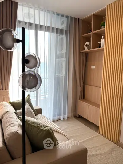 Modern living room with stylish decor and floor-to-ceiling windows