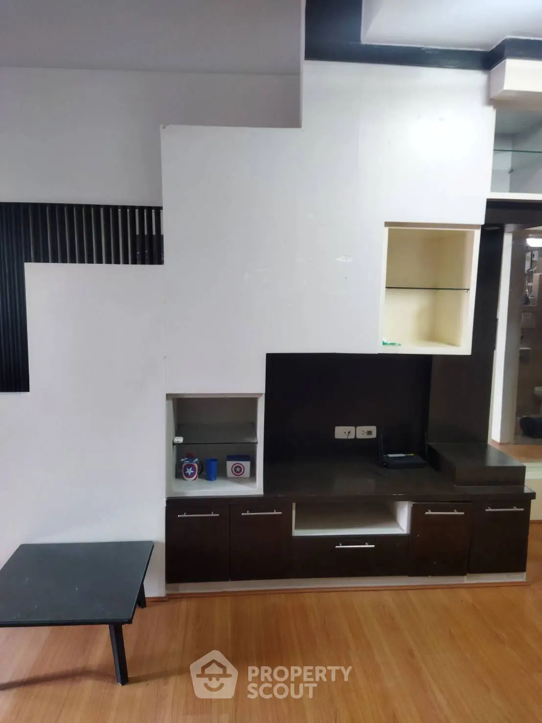 Modern living room with sleek built-in storage and wooden flooring