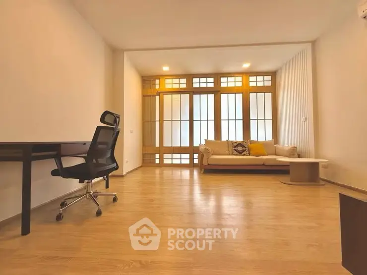Spacious modern living room with wooden flooring and stylish furniture