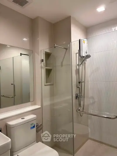 Modern bathroom with glass shower enclosure and sleek fixtures