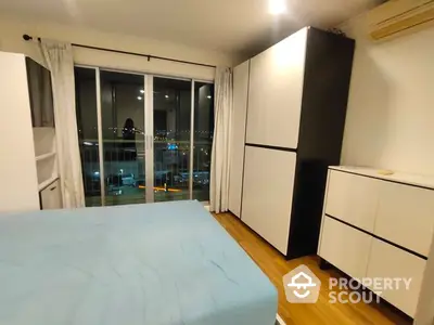 Modern bedroom with large wardrobe and city view balcony access