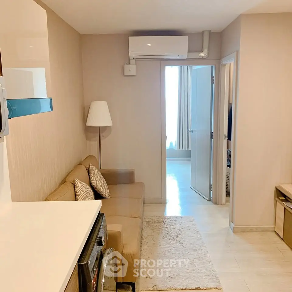 Cozy living room with modern decor and air conditioning in a stylish apartment.