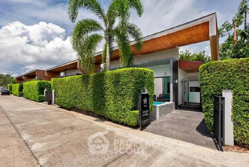 Modern architectural home with lush greenery and sleek design in a tropical setting.