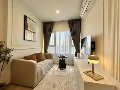 Modern living room with cozy sofa, stylish decor, and large window view.
