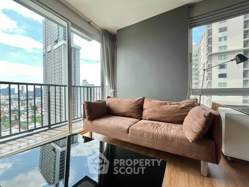 Modern living room with stunning city view and cozy brown sofa in high-rise apartment.
