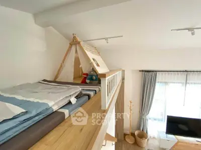 Charming loft-style bedroom with cozy sleeping area and natural light