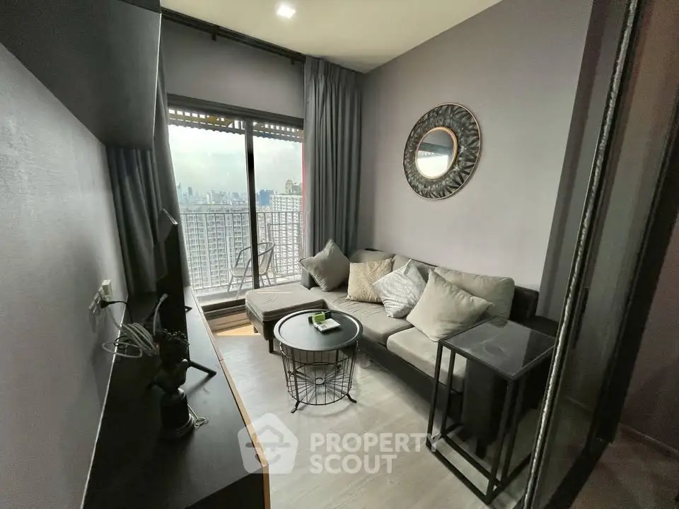 Modern living room with city view, cozy seating, and stylish decor in a high-rise apartment.