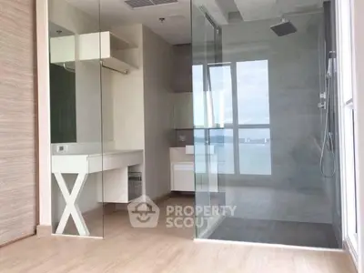 Modern bathroom with glass shower and wooden flooring