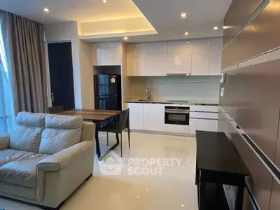 Modern open-layout kitchen and living room with sleek design and contemporary furniture.