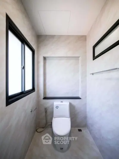 Modern bathroom with sleek design and natural light from window