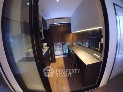 Modern kitchen with sleek design and ample natural light, featuring a closed layout and contemporary appliances.
