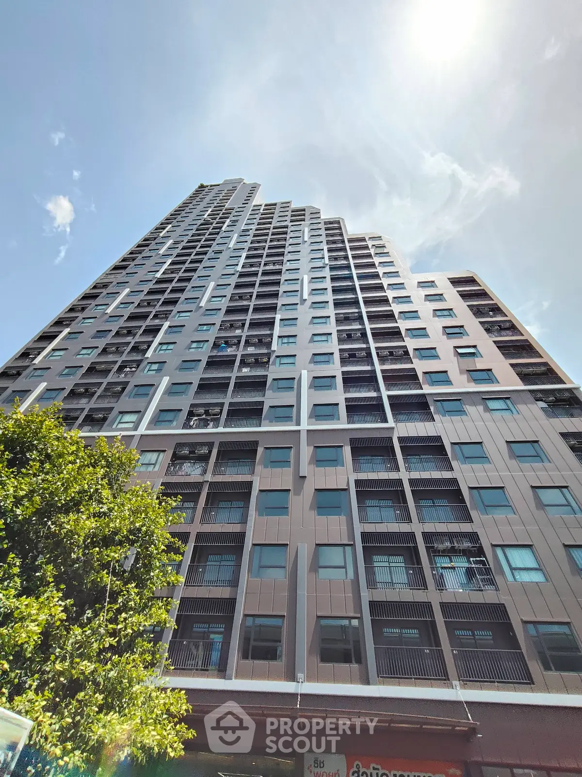 Stunning high-rise building with modern architecture and expansive windows, perfect for urban living.