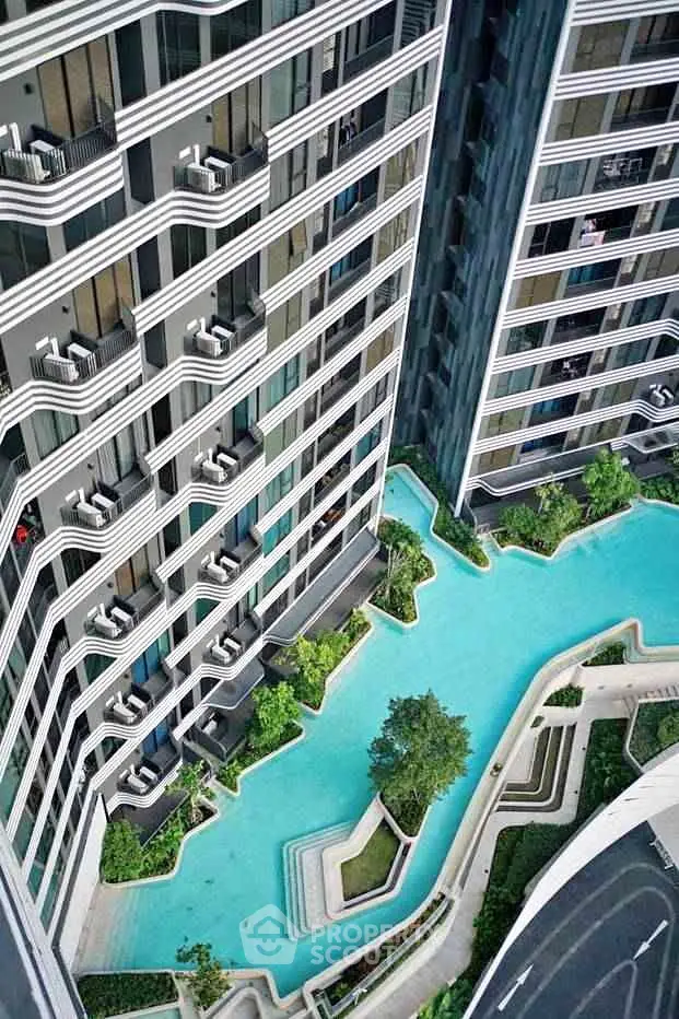 Luxurious high-rise building with stunning pool and modern architecture, perfect for urban living.