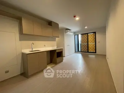 Modern apartment interior with open kitchen and balcony view
