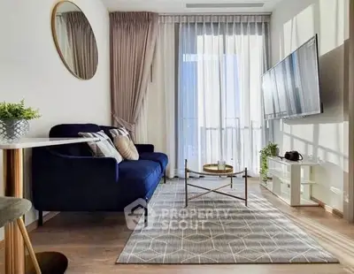 Stylish modern living room with elegant decor and large window view.