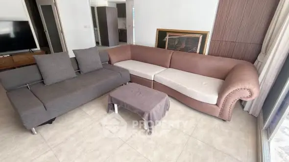 Spacious living room with modern sectional sofa and natural light