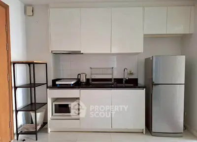Modern kitchen with sleek white cabinets and stainless steel appliances