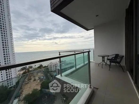 Spacious balcony with stunning ocean view in modern high-rise apartment