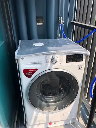 Modern washing machine on a balcony with sleek design and efficient features.
