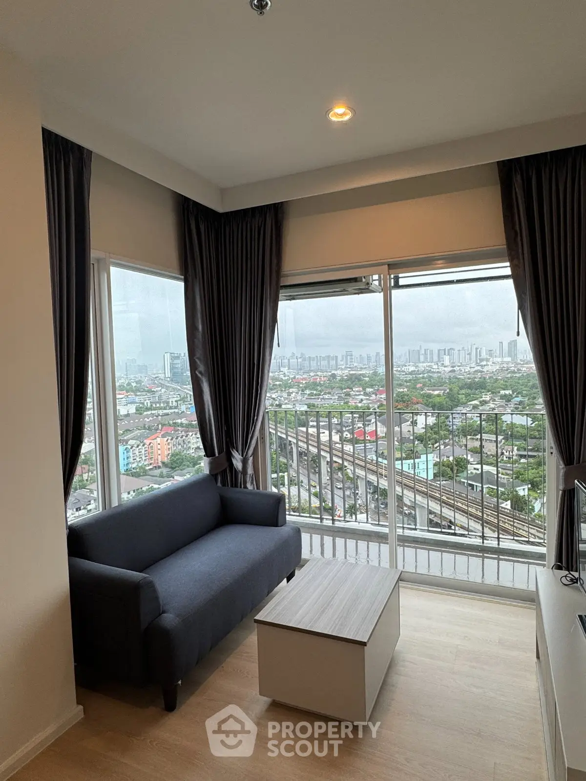 Modern living room with panoramic city view and stylish furniture