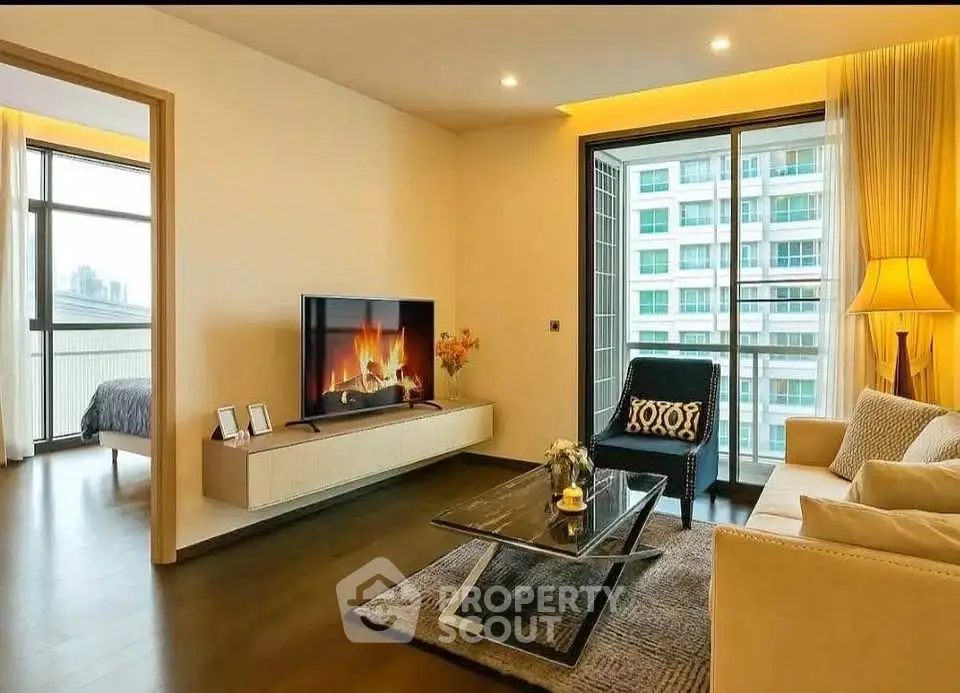Modern living room with elegant decor and city view, featuring a cozy fireplace and stylish furniture.