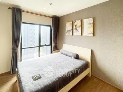 Modern bedroom with large window and stylish decor in high-rise apartment