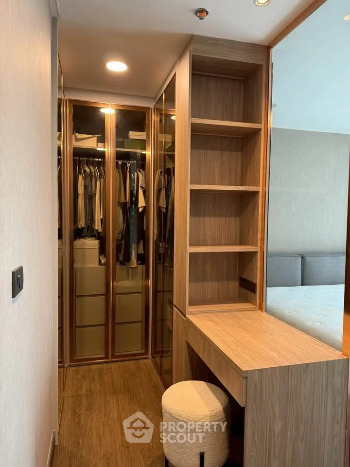 Modern bedroom with walk-in closet and wooden furniture, perfect for stylish living.