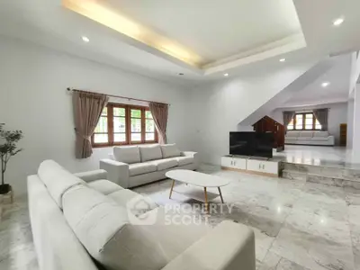 Spacious modern living room with elegant marble flooring and cozy seating area