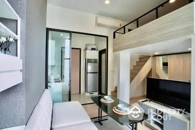 Modern loft-style living room with mezzanine and sleek kitchen