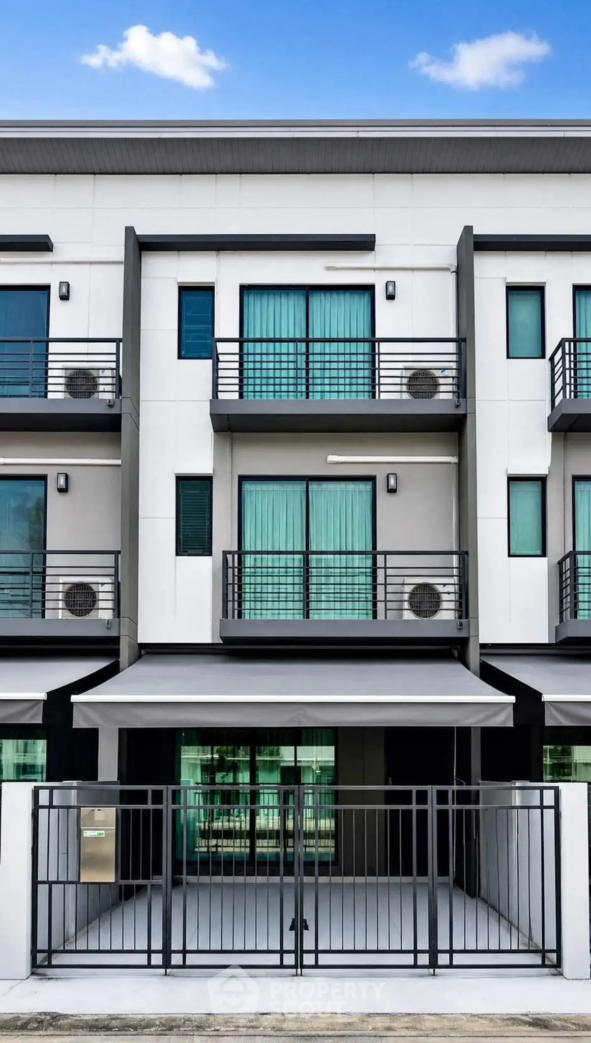 Modern townhouse exterior with sleek design and multiple balconies, perfect for urban living.