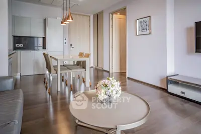 Modern living room with open kitchen and elegant decor in a stylish apartment.