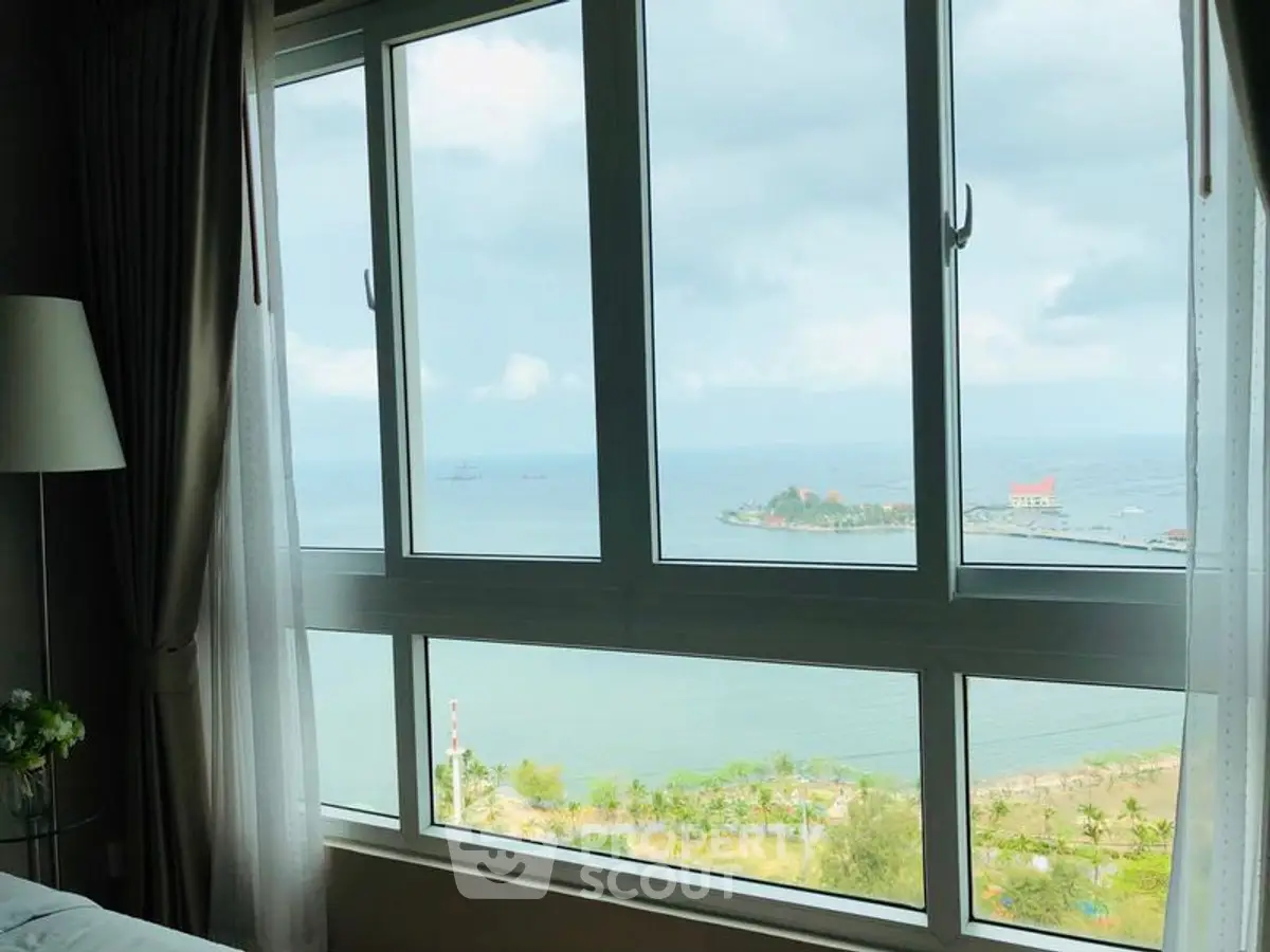 Stunning ocean view from a modern apartment window, perfect for serene living.