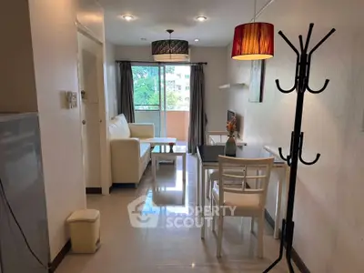 Charming living room with dining area and balcony view, featuring modern decor and ample natural light.