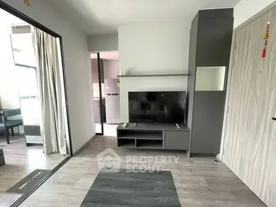 Modern living room with sleek TV unit and open layout in stylish apartment.