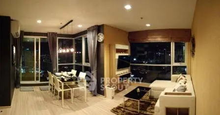 Spacious modern living room with panoramic city view and elegant dining area.