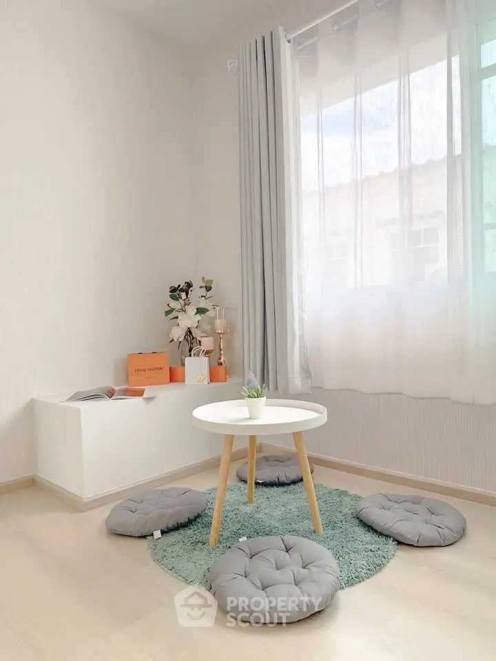Minimalist living room with natural light and cozy seating area
