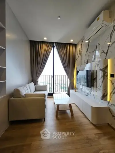 Modern living room with marble accent wall and cozy seating area.