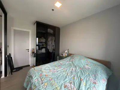 Cozy bedroom with modern wardrobe and playful bedding in a stylish apartment.