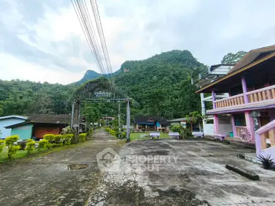 Charming rural property with lush mountain backdrop and traditional architecture, perfect for nature lovers.