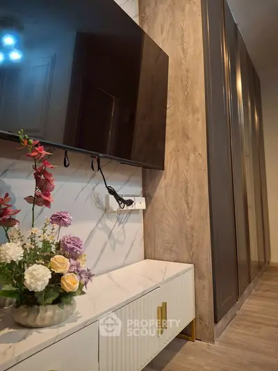 Modern living room with wall-mounted TV and elegant floral decor