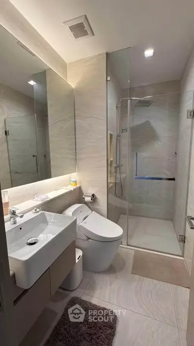 Modern bathroom with sleek fixtures and glass shower enclosure