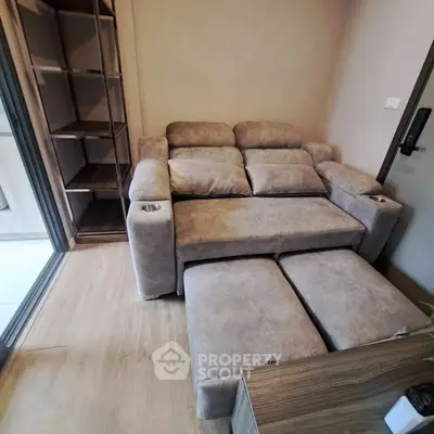 Cozy living room with plush sofa and modern shelving unit, perfect for relaxation and storage.