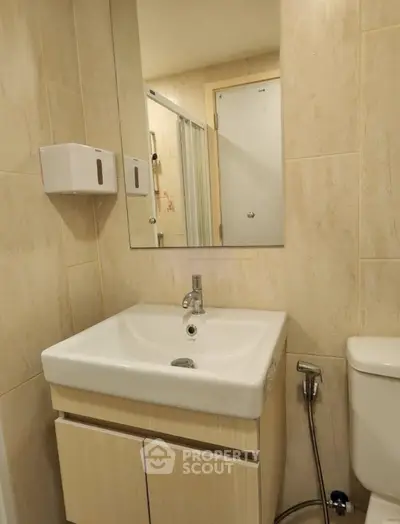 Modern bathroom with sleek sink and mirror in a stylish apartment.