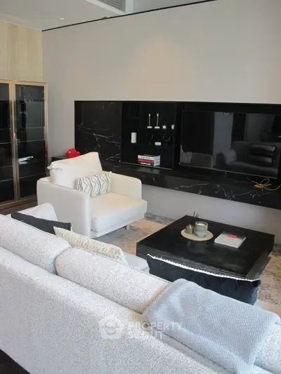 Luxurious modern living room with elegant furniture and sleek black accents