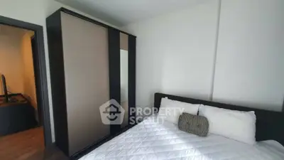 Modern bedroom with sleek wardrobe and cozy bed in stylish apartment.