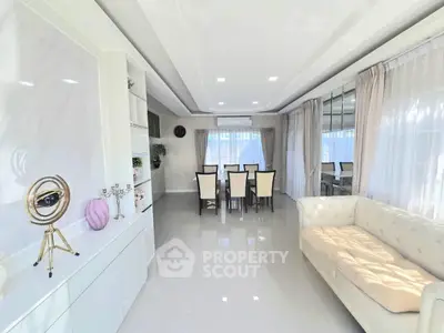 Elegant living room with modern decor and spacious dining area