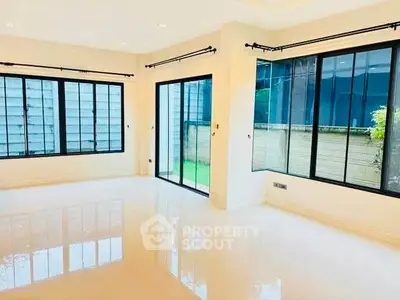 Spacious corner unit with large windows and glossy floors, offering abundant natural light.