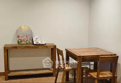 Charming dining area with wooden table and chairs, perfect for cozy meals.