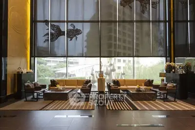 Luxurious lobby with modern decor and floor-to-ceiling windows offering a stunning view.
